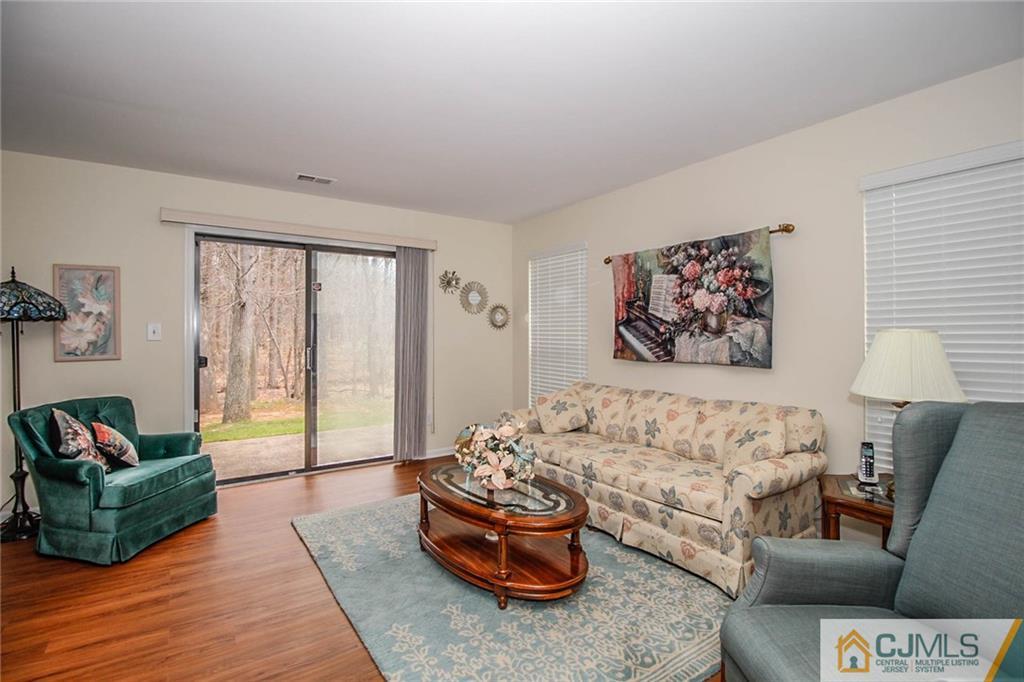 2106 Timber Oaks Road, Unit 2106 Edison, NJ 08820 - Photo 6 of 25 a living room with furniture and a large window