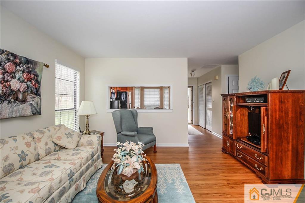 2106 Timber Oaks Road, Unit 2106 Edison, NJ 08820 - Photo 8 of 25 a living room with furniture and wooden floor