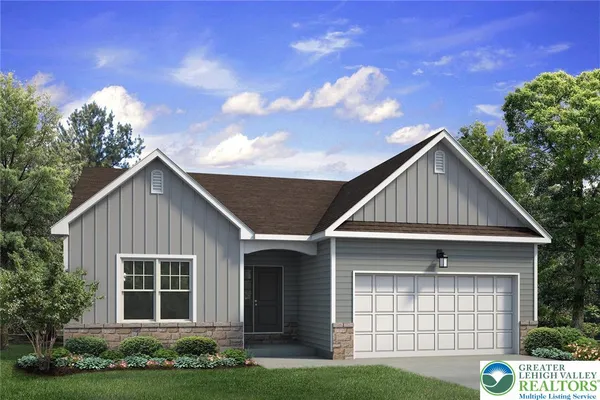 a front view of a house with a garden and plants