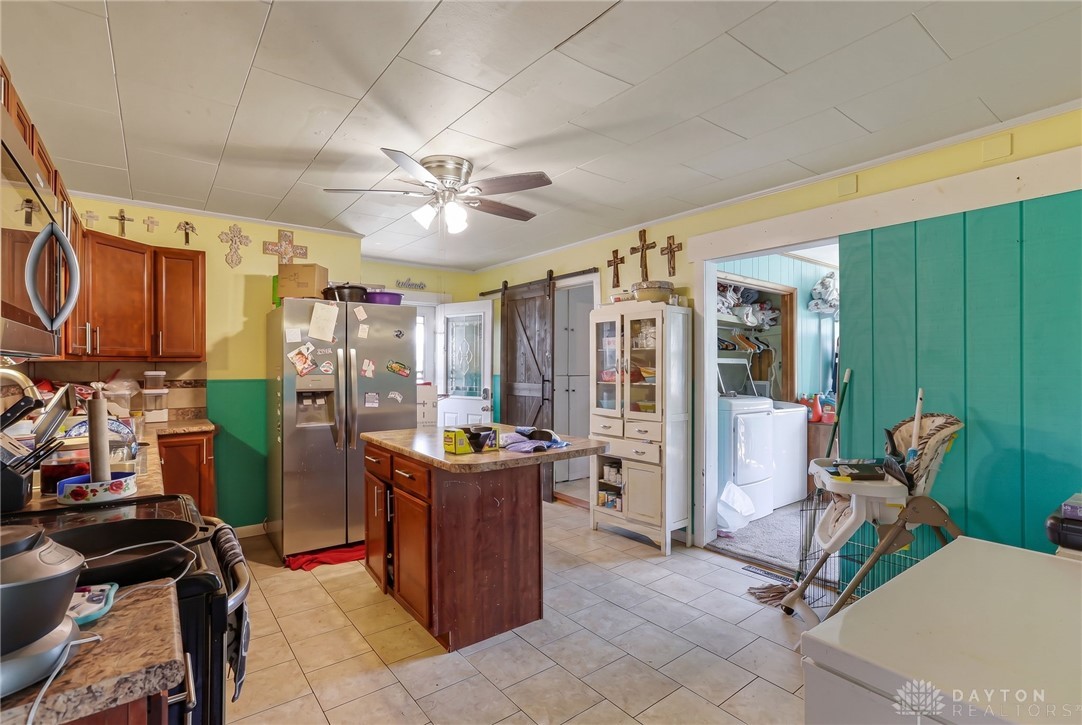 2390 Ridge Road Zanesville, OH 43701 - Photo 12 of 45 This spacious kitchen offers a functional layout, with ample counter space and convenient laundry access.