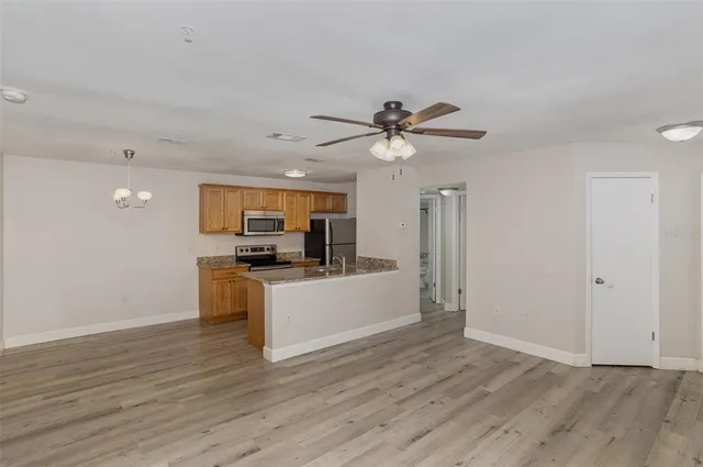 a view of a kitchen with a sink a kitchen counter top space and stainless steel appliances