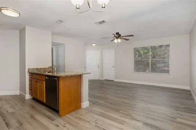 a view of kitchen with granite countertop cabinets and wooden floor