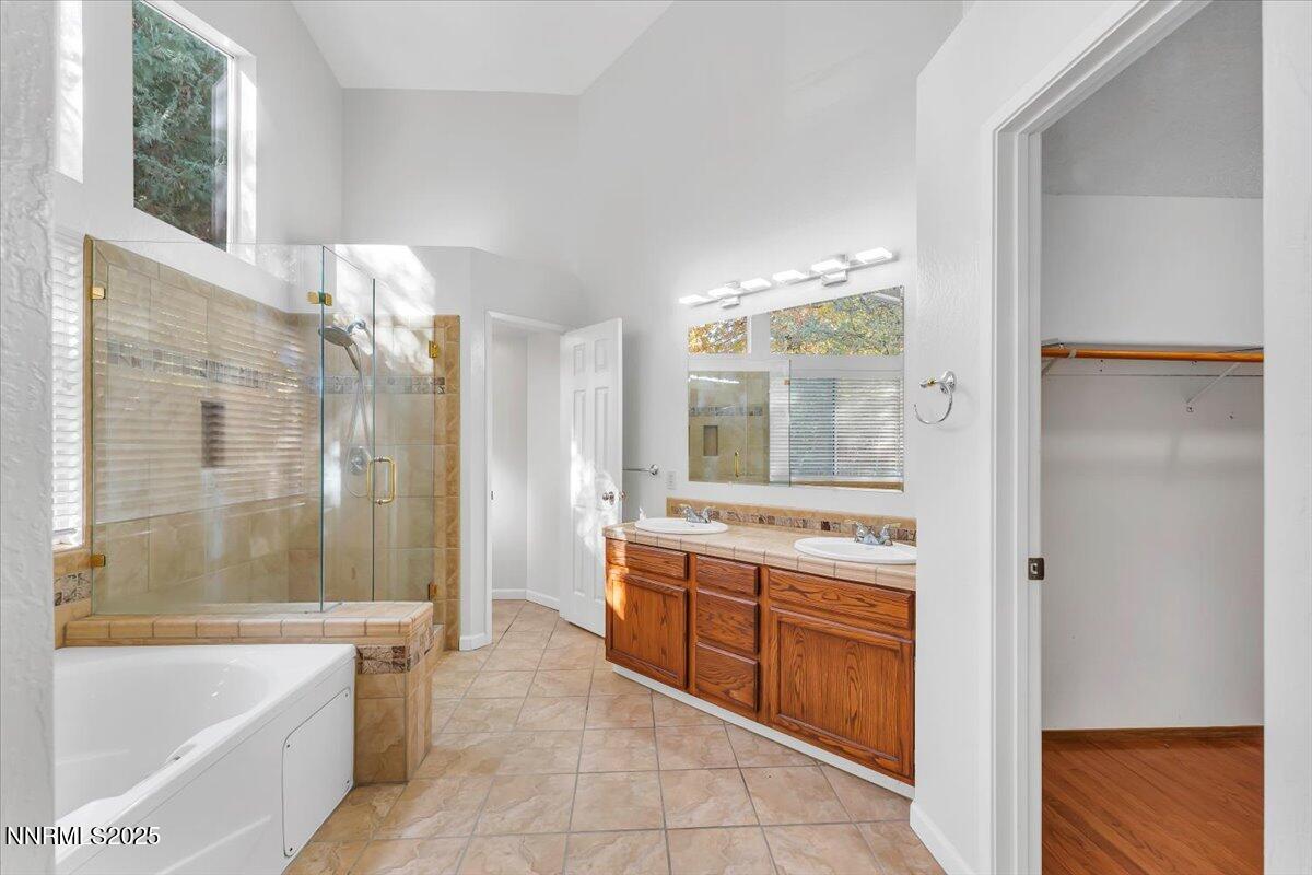 4434 Whitney Circle Sparks, NV 89436 - Photo 20 of 32 a bathroom with a granite countertop sink a bathtub and shower