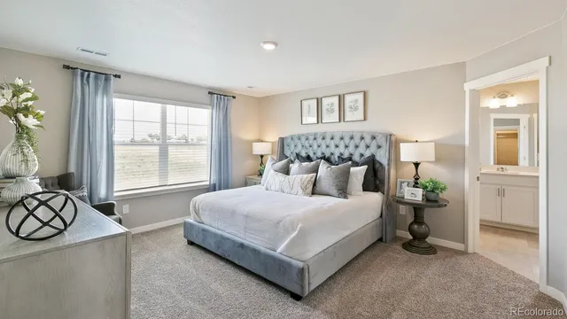 a bedroom with a large bed and a night stand