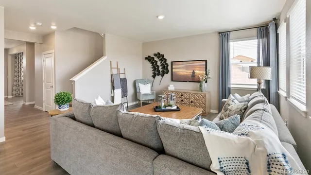 a living room with furniture and wooden floor