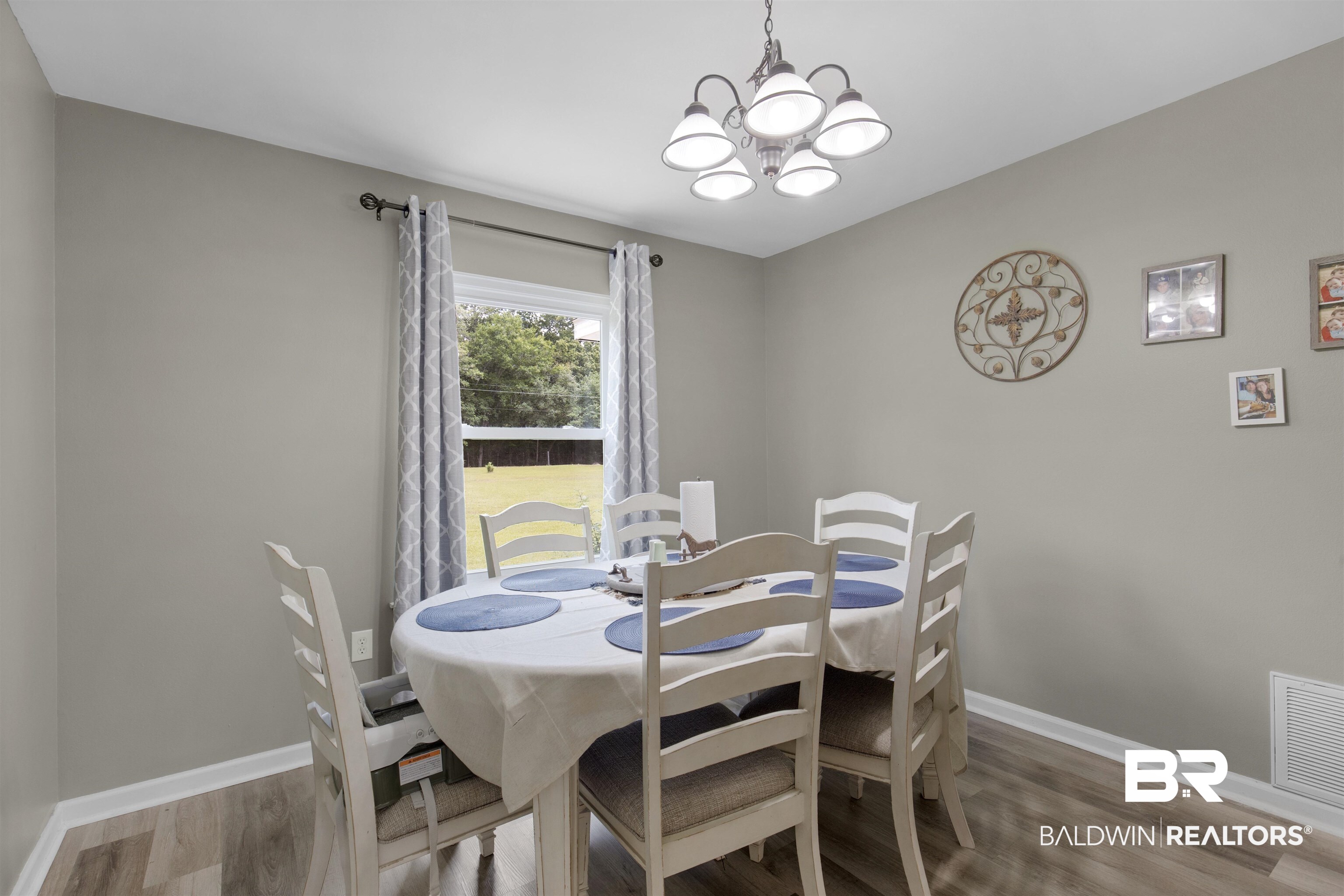 13925 Fort Lake Road Grand Bay, AL 36541 - Photo 15 of 37 Dining area with baseboards, wood finished floors, a notable chandelier, and visible vents