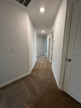 wooden floor in an empty room with a ceiling fan