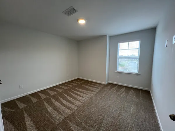 a backyard of a house with barbeque stove and furniture