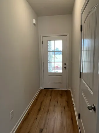 a kitchen with a sink and wooden floor