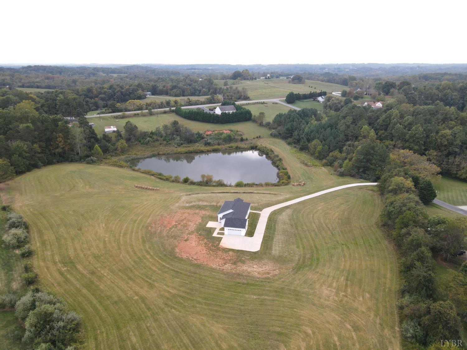 203 Longhill Road Goode, VA 24556 - Photo 1 of 26 an aerial view of a house with a yard