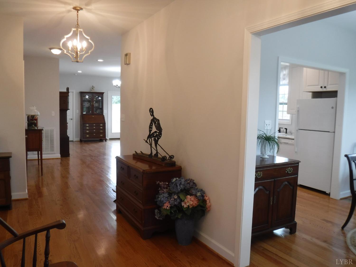 203 Longhill Road Goode, VA 24556 - Photo 11 of 26 a living room with furniture and a chandelier