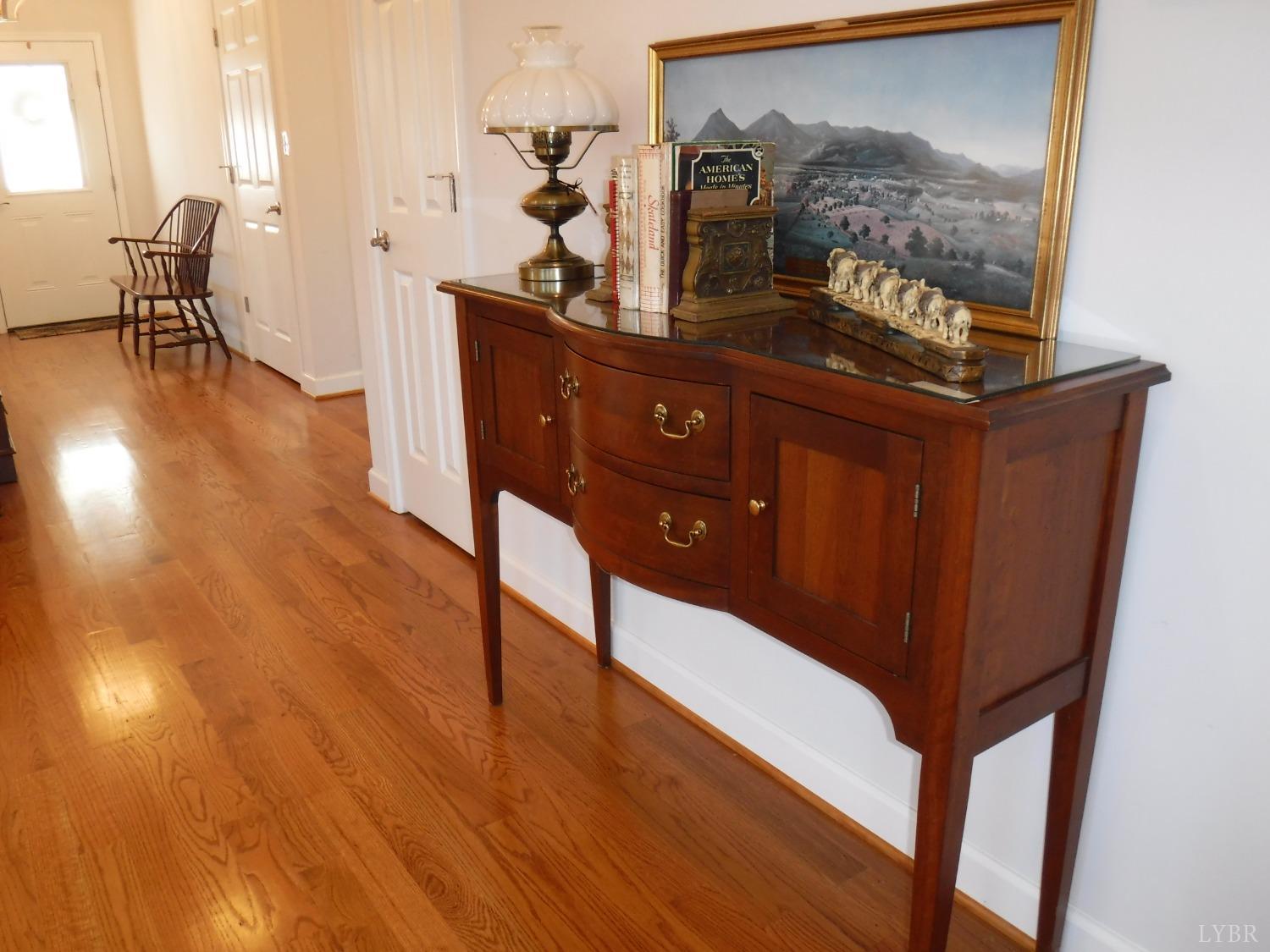 203 Longhill Road Goode, VA 24556 - Photo 15 of 26 a view of a hallway with wooden floor and furniture