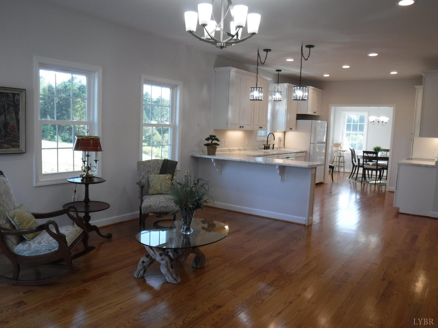 203 Longhill Road Goode, VA 24556 - Photo 20 of 26 a living room with furniture chandelier and a table