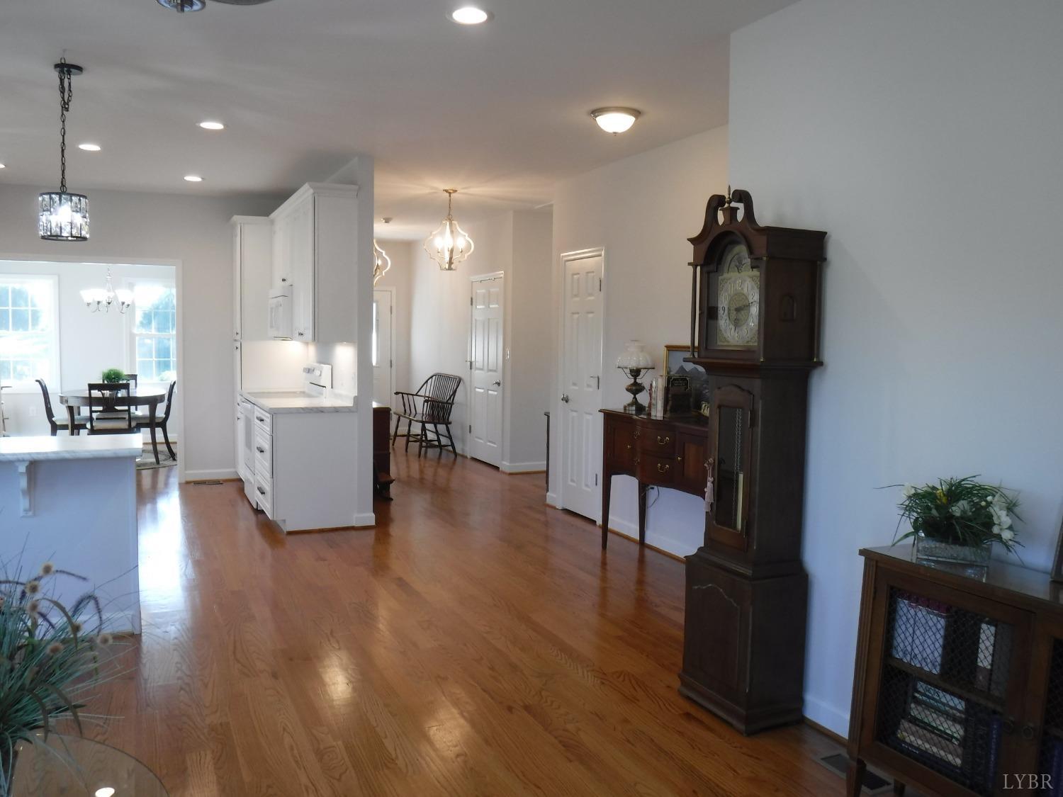 203 Longhill Road Goode, VA 24556 - Photo 21 of 26 a living room with fireplace furniture and a wooden floor