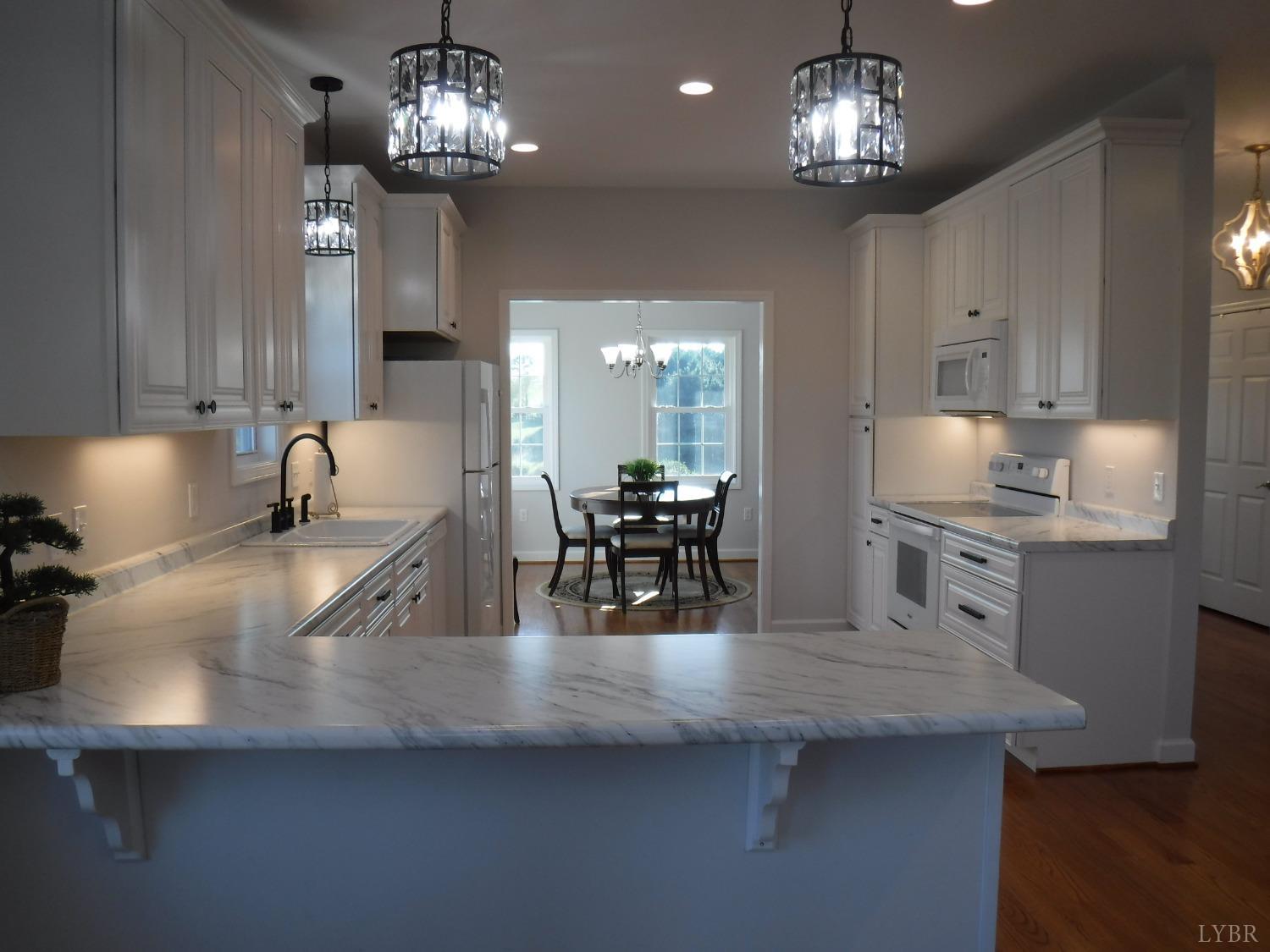 203 Longhill Road Goode, VA 24556 - Photo 24 of 26 a kitchen with stainless steel appliances granite countertop a sink refrigerator and cabinets