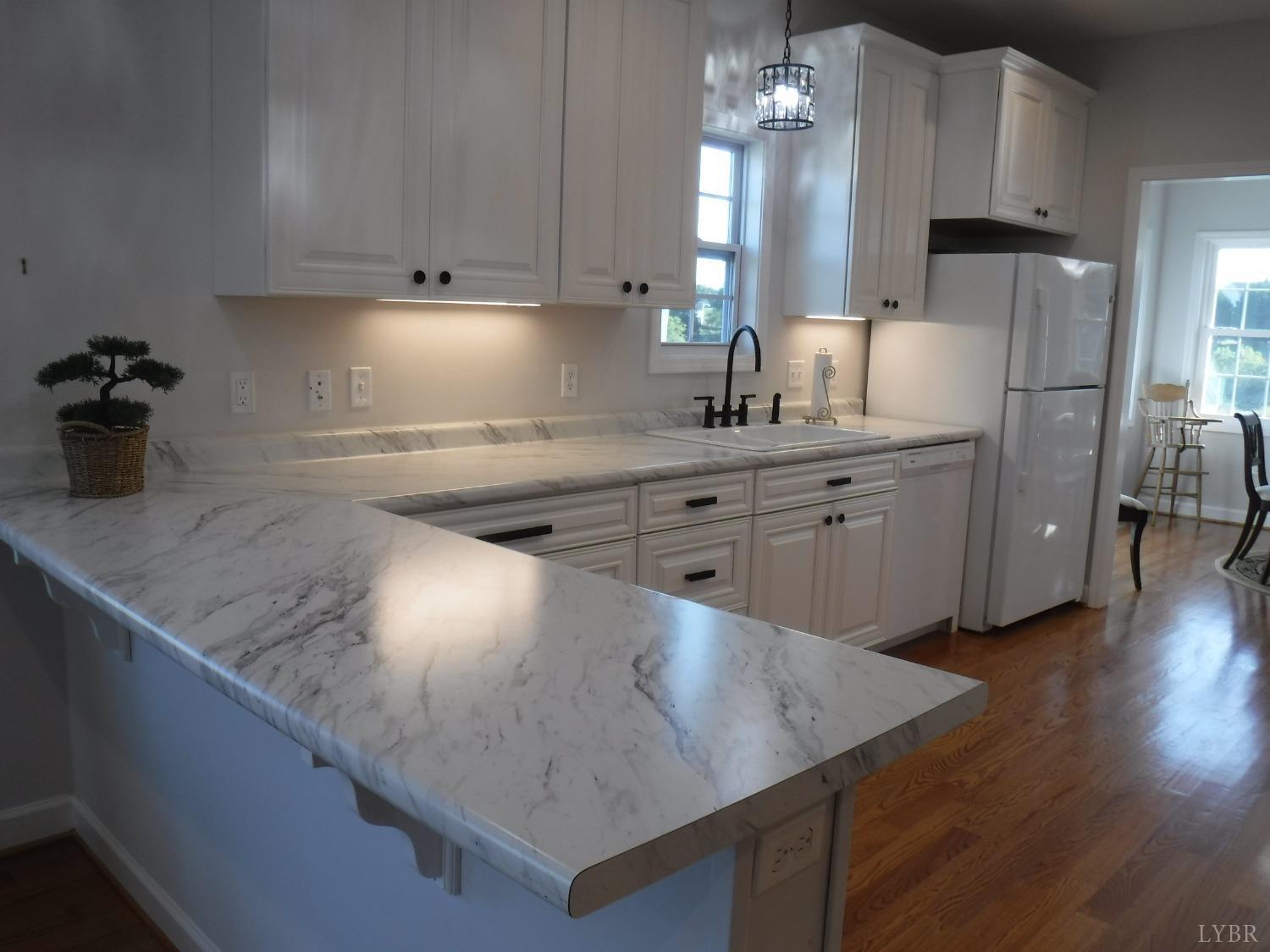 203 Longhill Road Goode, VA 24556 - Photo 26 of 26 a kitchen with refrigerator and cabinets
