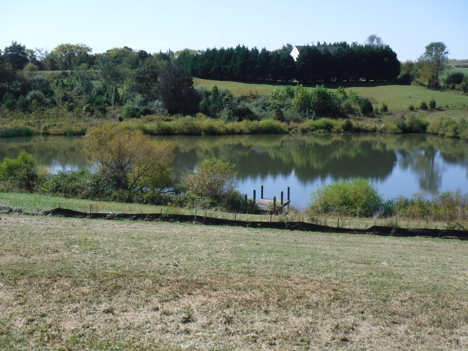 203 Longhill Road Goode, VA 24556 - Photo 5 of 26 a view of a lake in middle of a field