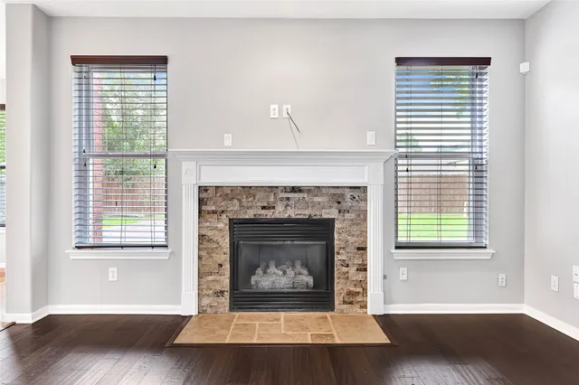 a living room with a fireplace and a window
