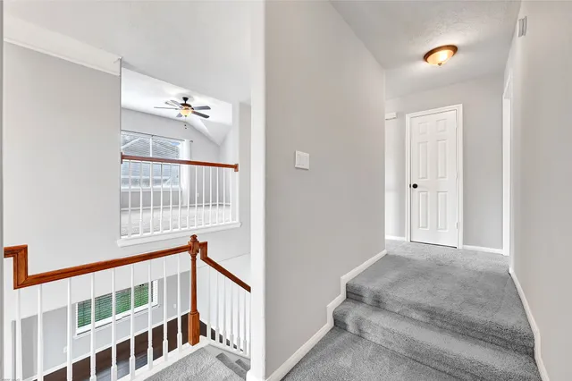 a view of staircase with white walls