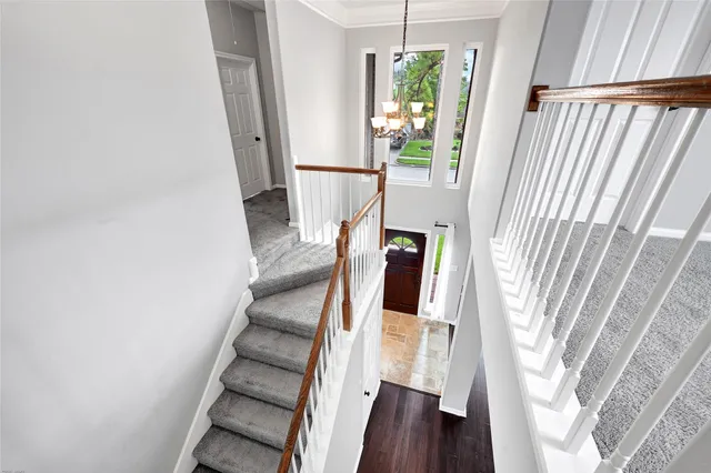 a view of staircase with wooden floor and window