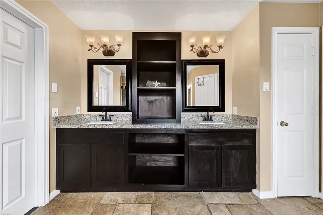 a kitchen with a sink and stainless steel appliances