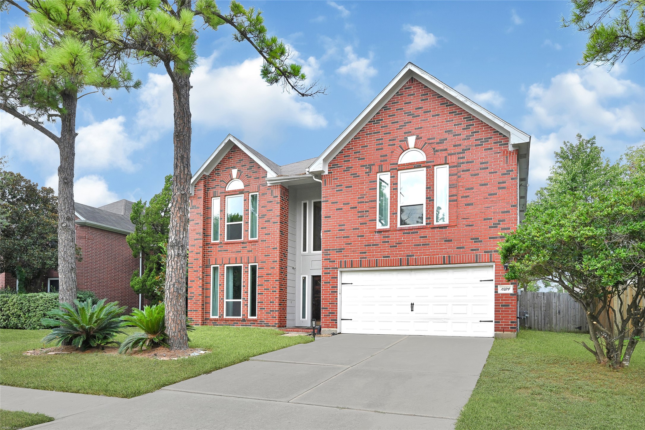 10219 Sable Trail Lane Houston, TX 77064 - Photo 2 of 31 a front view of a house with a yard and garage