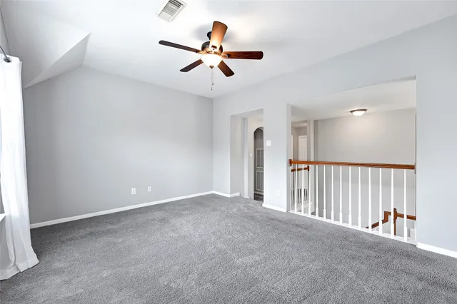 a view of a livingroom with a ceiling fan and window
