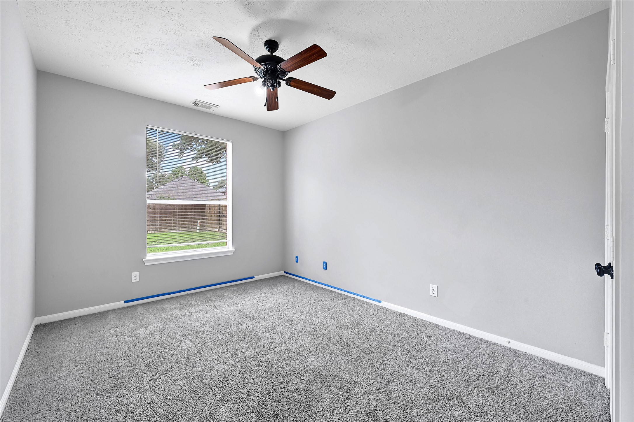 10219 Sable Trail Lane Houston, TX 77064 - Photo 28 of 31 an empty room with ceiling fan and windows