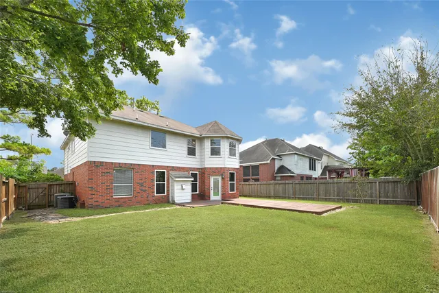 a view of a house with a backyard