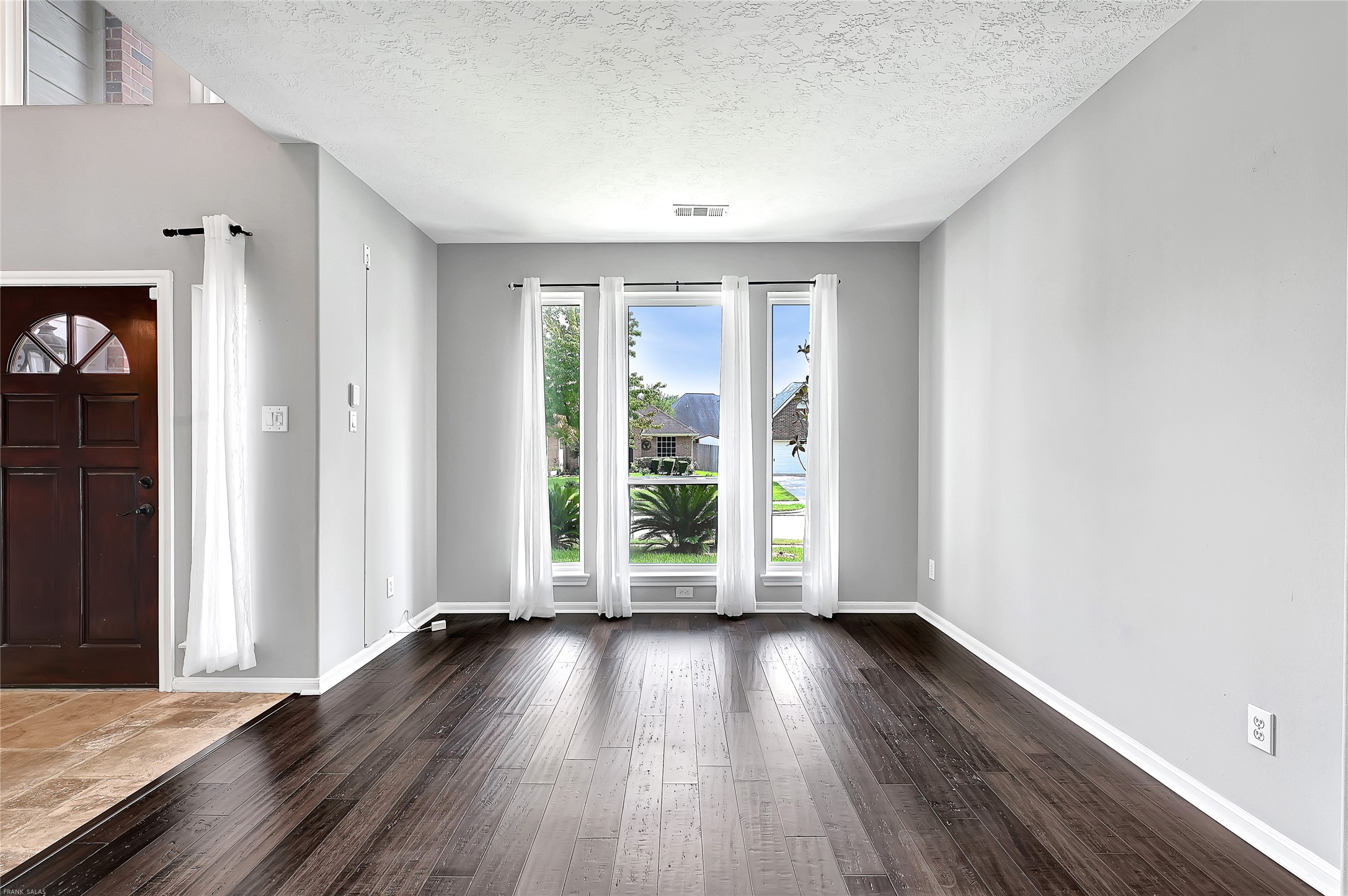 10219 Sable Trail Lane Houston, TX 77064 - Photo 4 of 31 an empty room with wooden floor and windows