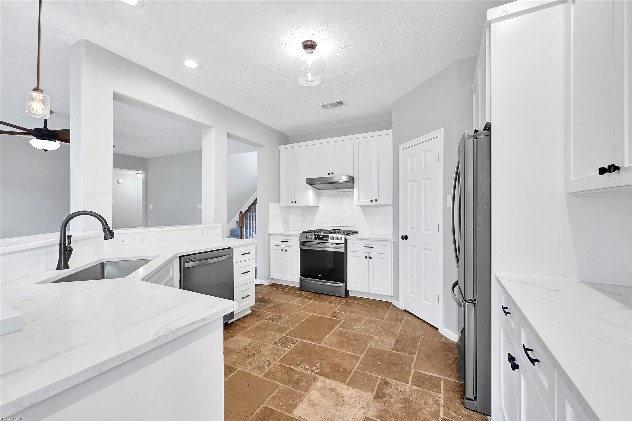 10219 Sable Trail Lane Houston, TX 77064 - Photo 6 of 31 a kitchen with stainless steel appliances a refrigerator sink and white cabinets