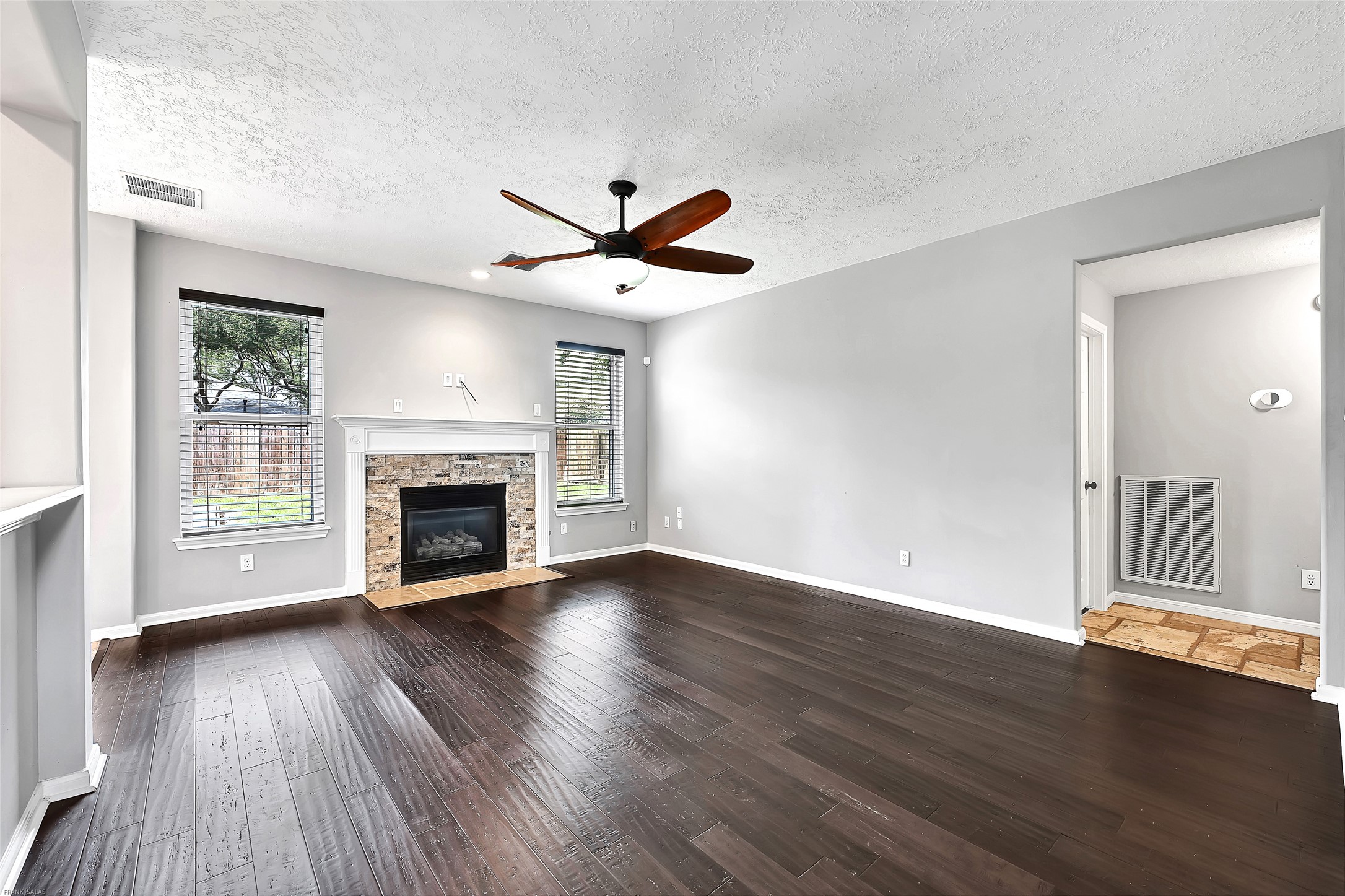 10219 Sable Trail Lane Houston, TX 77064 - Photo 10 of 31 an empty room with wooden floor a ceiling fan and windows