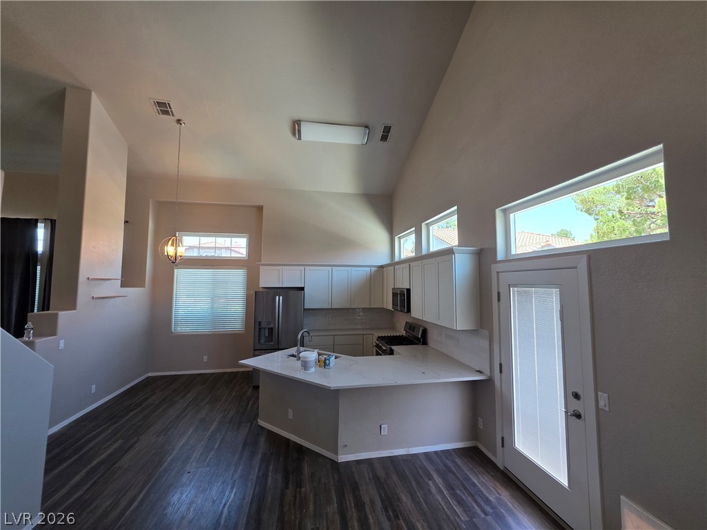 2275 Ramsgate Drive Henderson, NV 89074 - Photo 32 of 84 Vast ceilings and abundant windows illuminate this contemporary kitchen, featuring ample counter space.