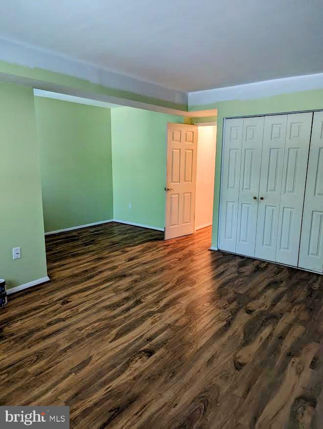 1621 Parkcrest Circle, Unit 101 Reston, VA 20190 - Photo 13 of 16 a view of an empty room with wooden floor and a window