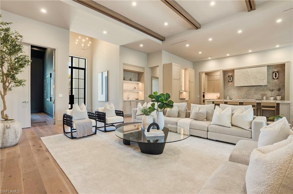 4851 Crayton Road Naples, FL 34103 - Photo 6 of 33 Open-concept living area with high ceilings, recessed lighting, and wood-finish flooring