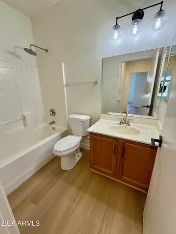 a bathroom with a double vanity sink toilet mirror and bathtub