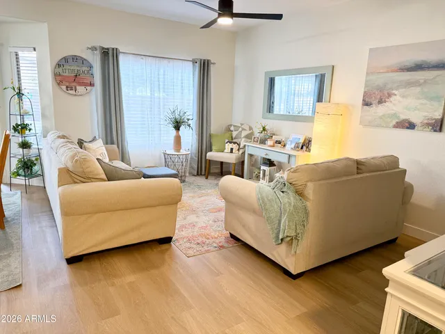 a living room with furniture and a wooden floor