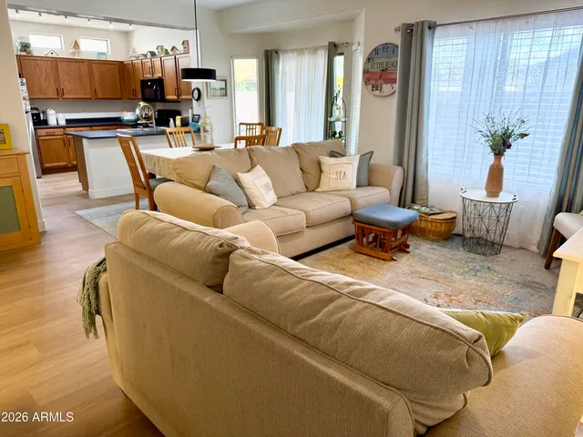 a living room with furniture and kitchen view
