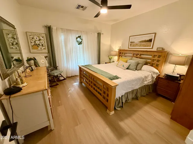 a bedroom with a bed and wooden floor