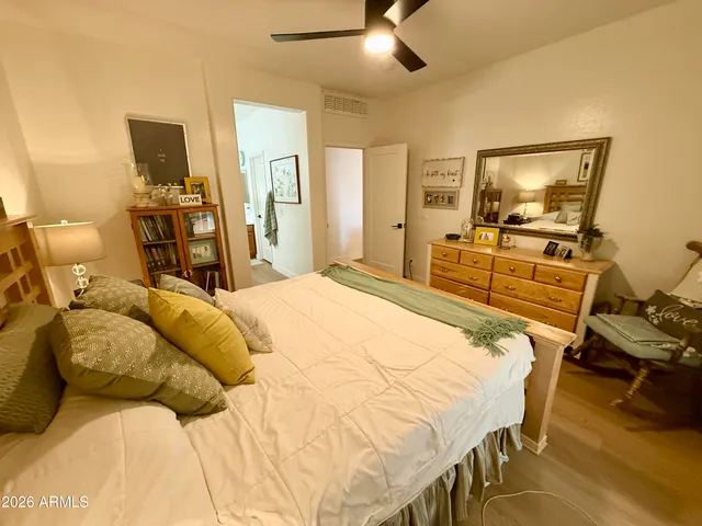 a bedroom with a bed and wooden floor