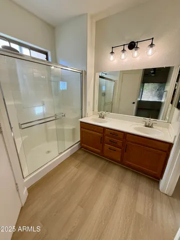 a bathroom with a double vanity sink and mirror