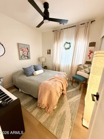 a bedroom with a bed and wooden floor