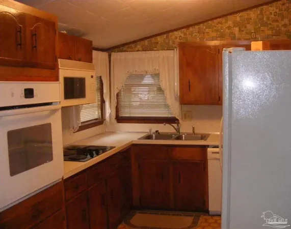 a kitchen with stainless steel appliances a sink stove and cabinets