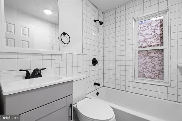 a bathroom with a sink mirror bathtub and shower
