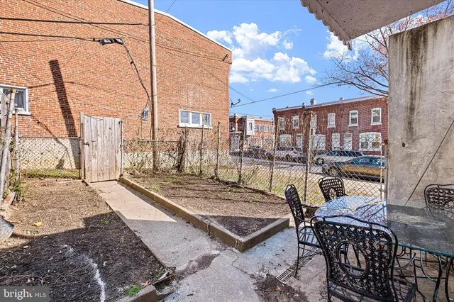 a view of a patio with a table and chairs