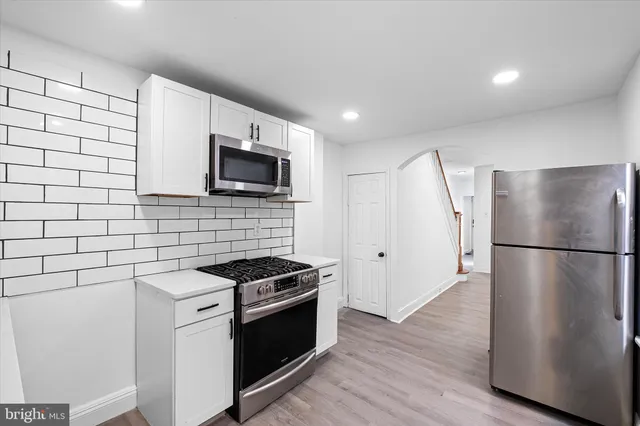 a kitchen with a refrigerator sink and stove