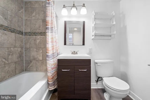 a bathroom with a sink a toilet and bathtub
