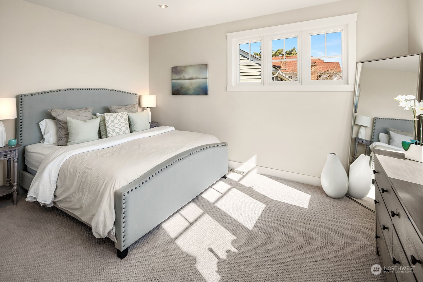 5108 Northeast 42nd Street Seattle, WA 98105 - Photo 15 of 40 a bedroom with a bed and lamp