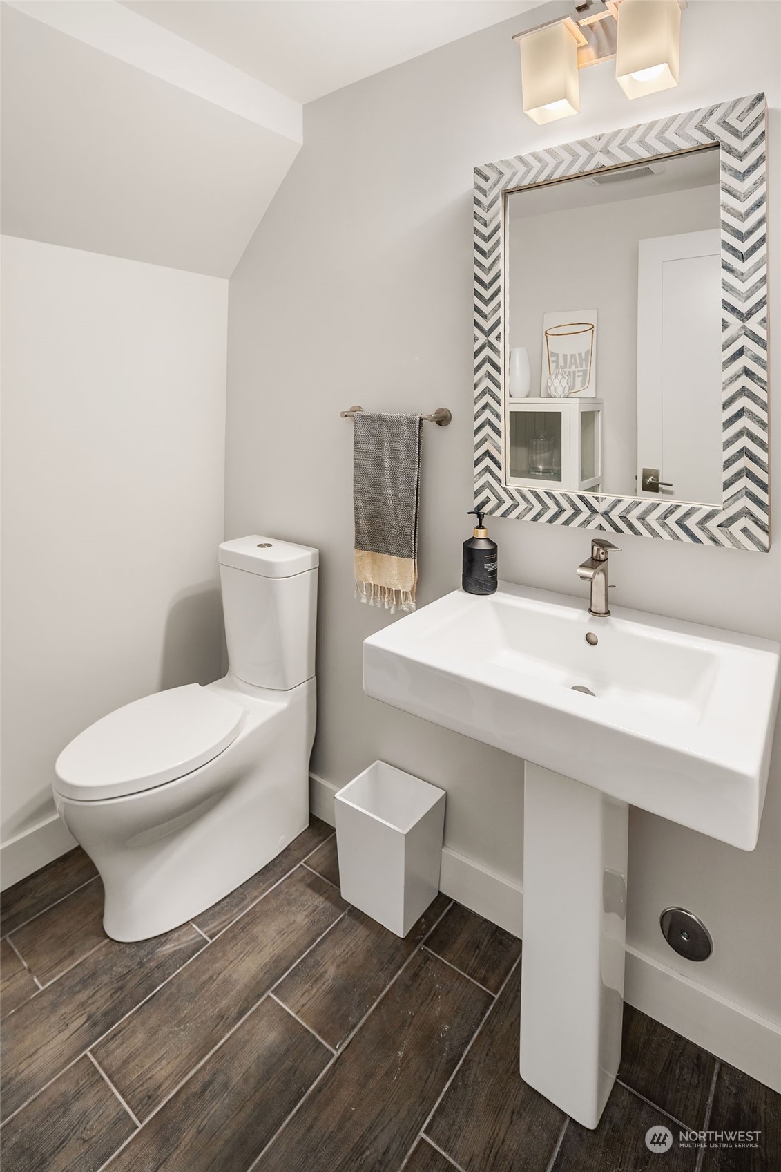 5108 Northeast 42nd Street Seattle, WA 98105 - Photo 27 of 40 a bathroom with a toilet a sink and mirror