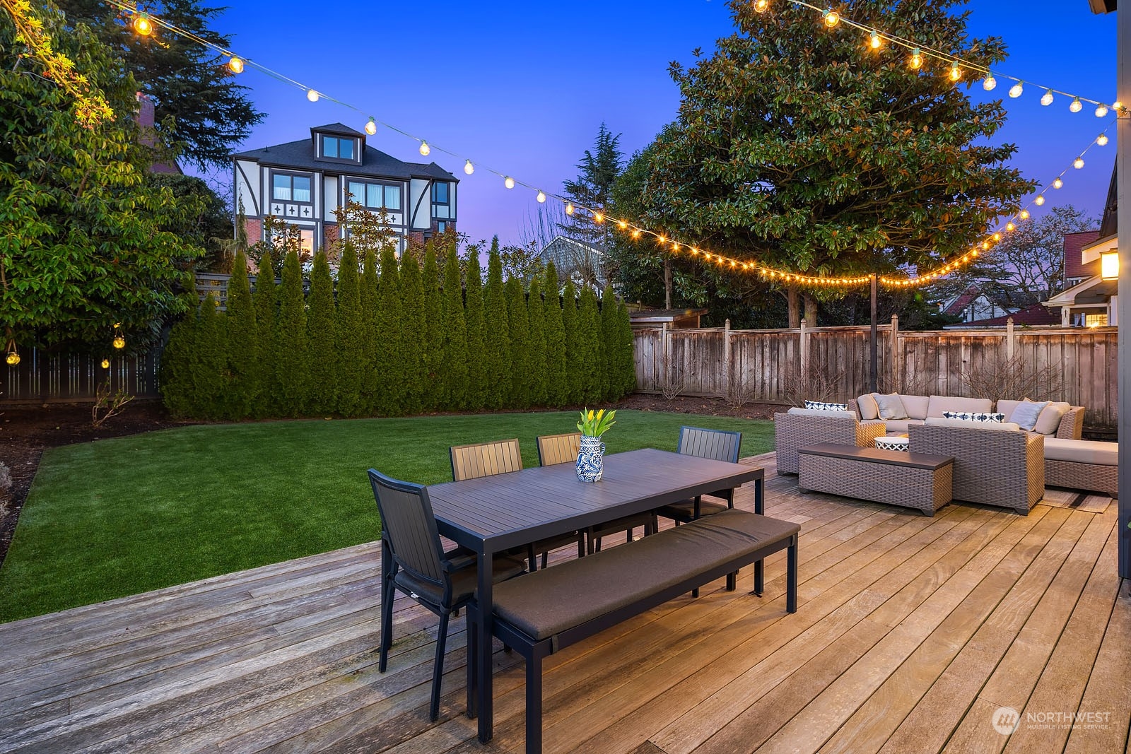 5108 Northeast 42nd Street Seattle, WA 98105 - Photo 33 of 40 a view of a patio with couches table and chairs and wooden fence